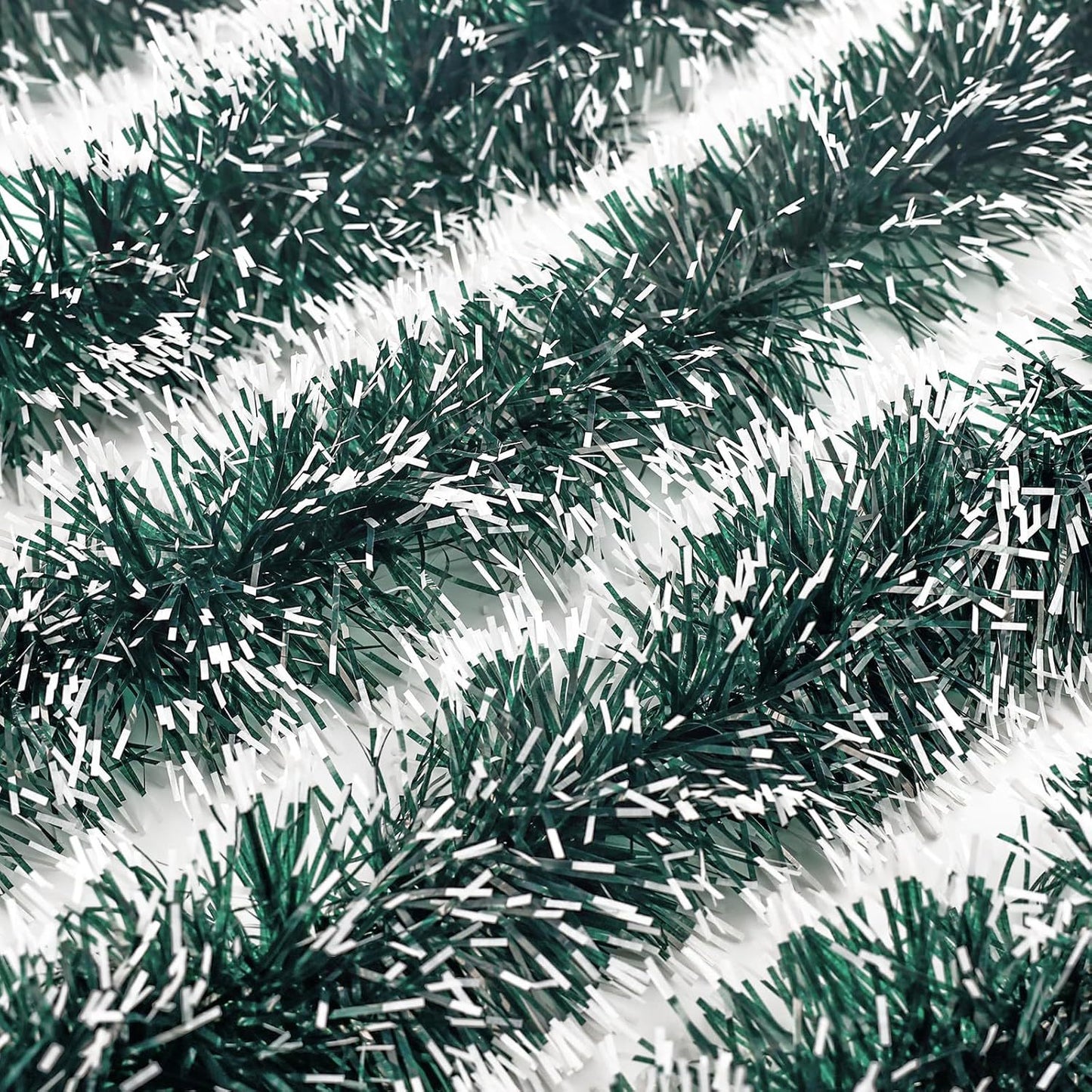 Green tinsel garland on a white background