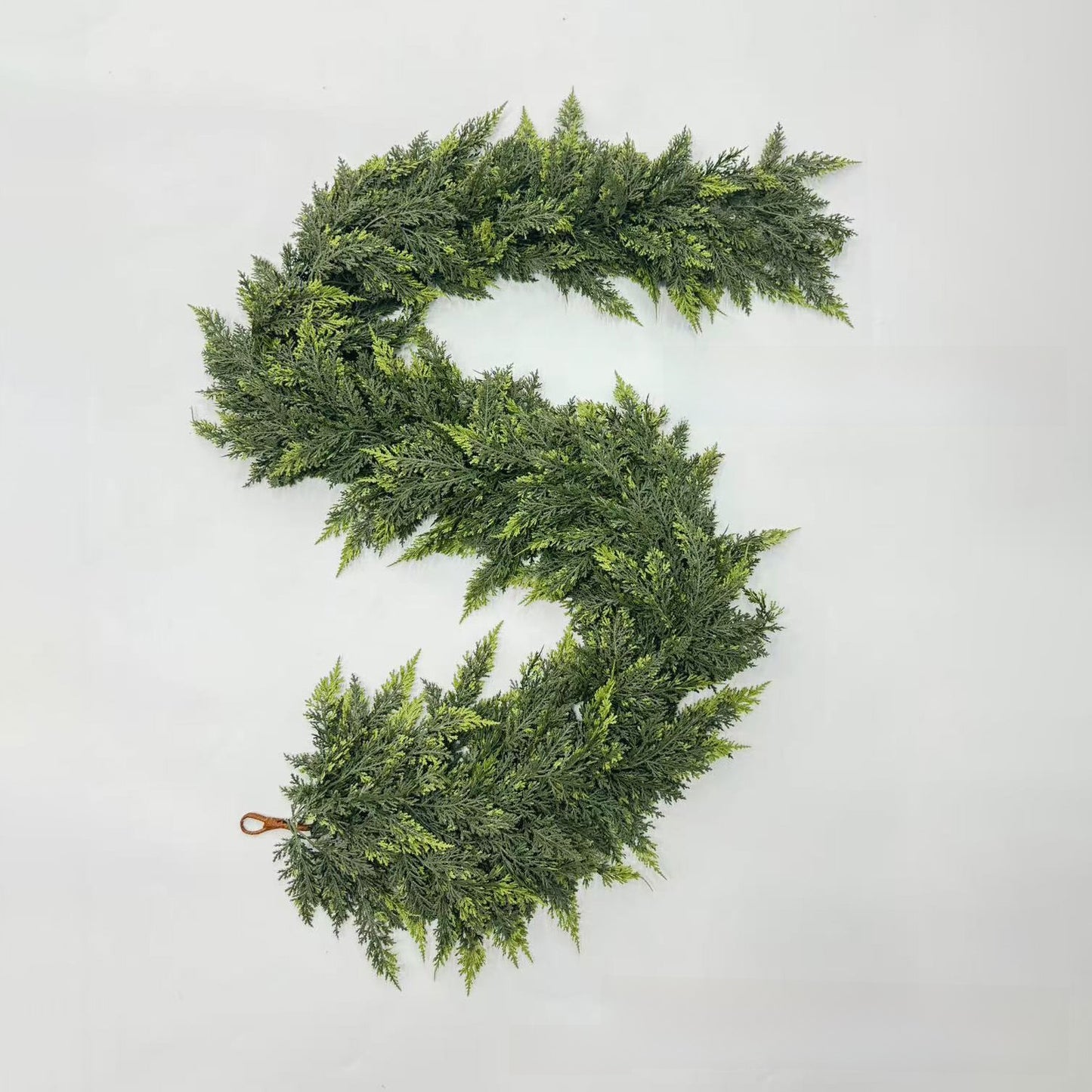 Green artificial wreath on a light gray background