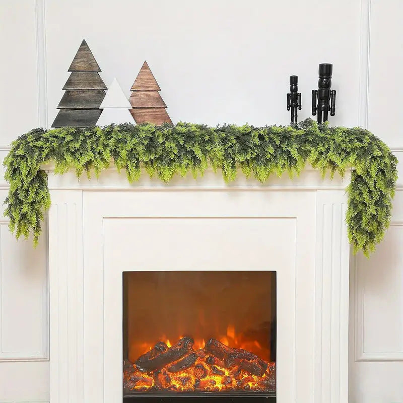 Decorative fireplace with mantel decorated with greenery and wooden trees.