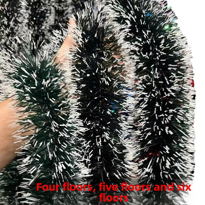 Black and silver tinsel garlands held by a hand with text overlay.