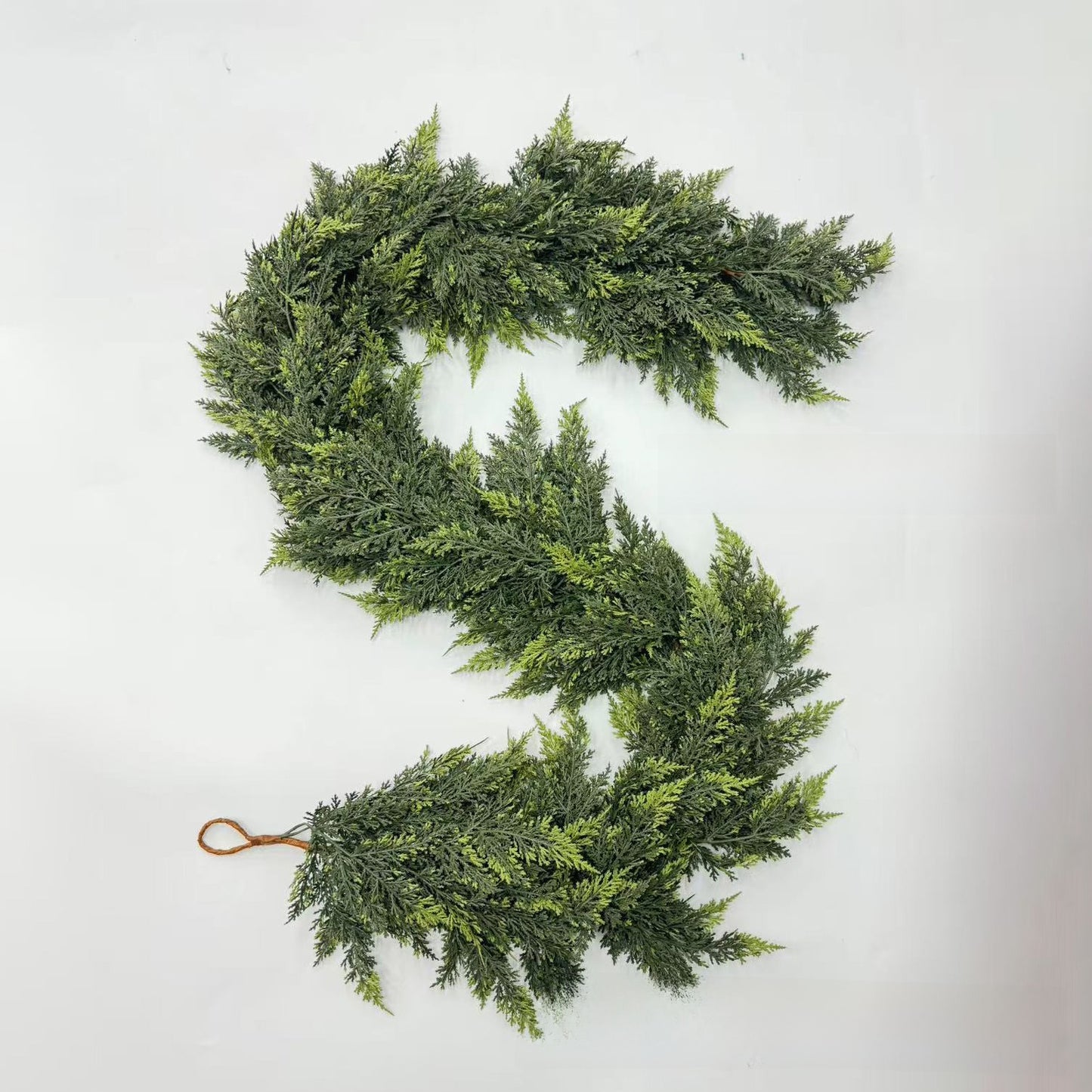 Green artificial wreath on a white background