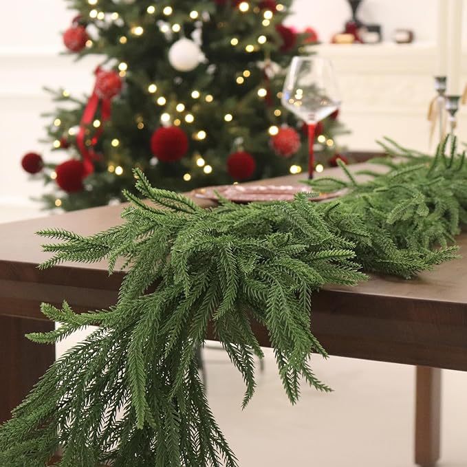 Green table runner on a table with a decorated Christmas tree in the background