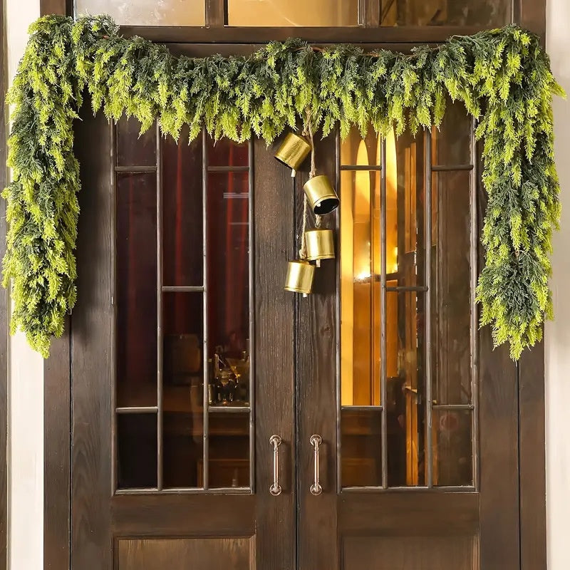Decorative greenery with gold accents on a wooden door