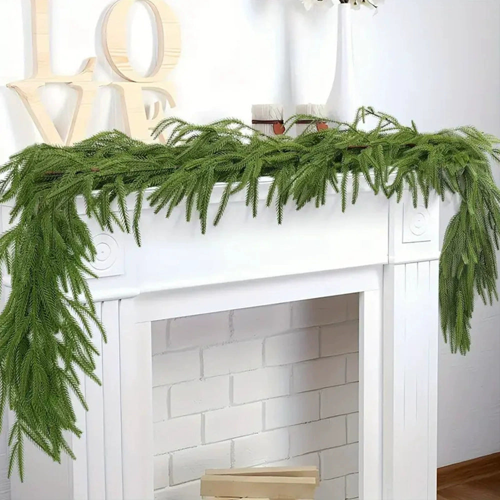 Green garland on a white fireplace with 'LOVE' letters above