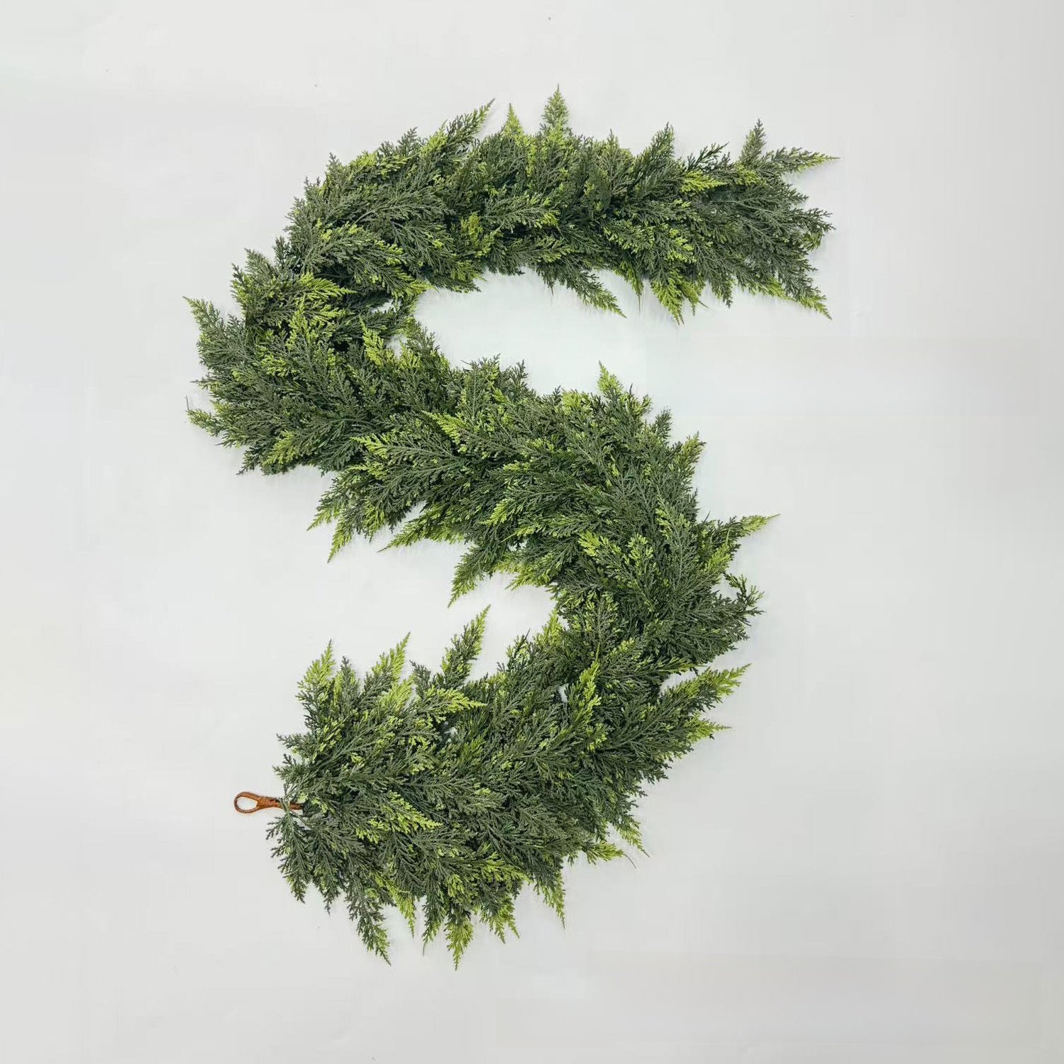 Green artificial wreath on a light gray background