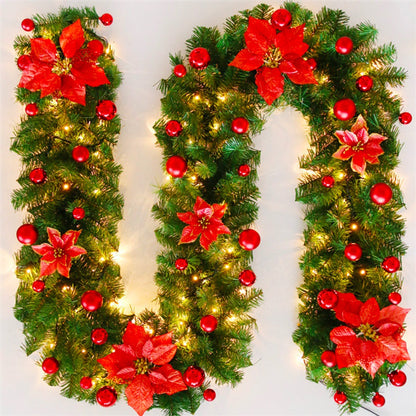 Decorative Christmas letter 'U' made of greenery, red flowers, and lights on a white background