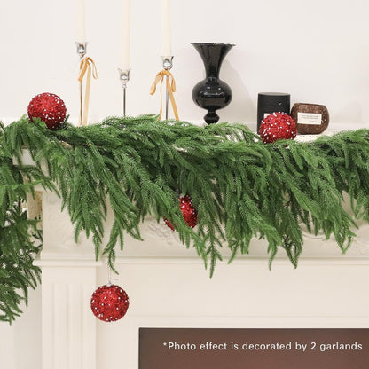 Decorative mantel with green garland and red ornaments, featuring a photo effect of two garlands.