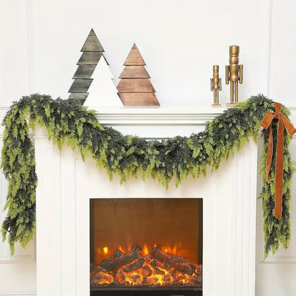 Decorative fireplace mantel with green garland, wooden trees, and a nutcracker.
