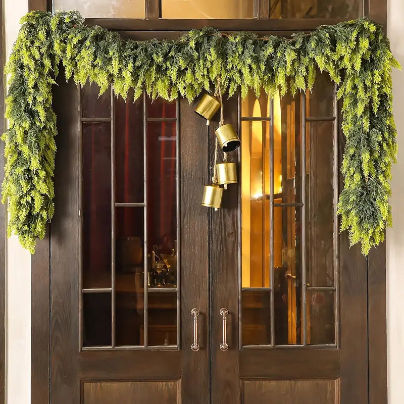 Decorative greenery and gold lanterns on a wooden door