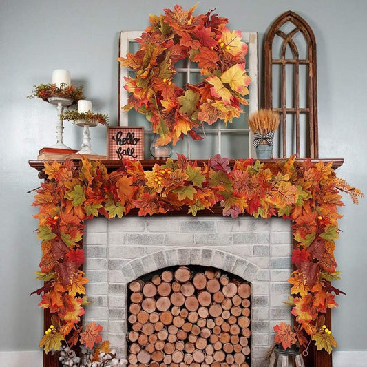Decorative autumn wreath and garland on a fireplace mantel with candles and a small sign.