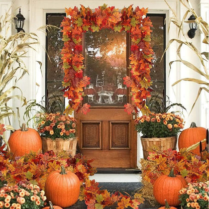Front door decorated with autumn leaves, pumpkins, and flowers on a porch.