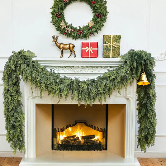 Decorative fireplace mantel with greenery, wreath, and festive items against a white wall.
