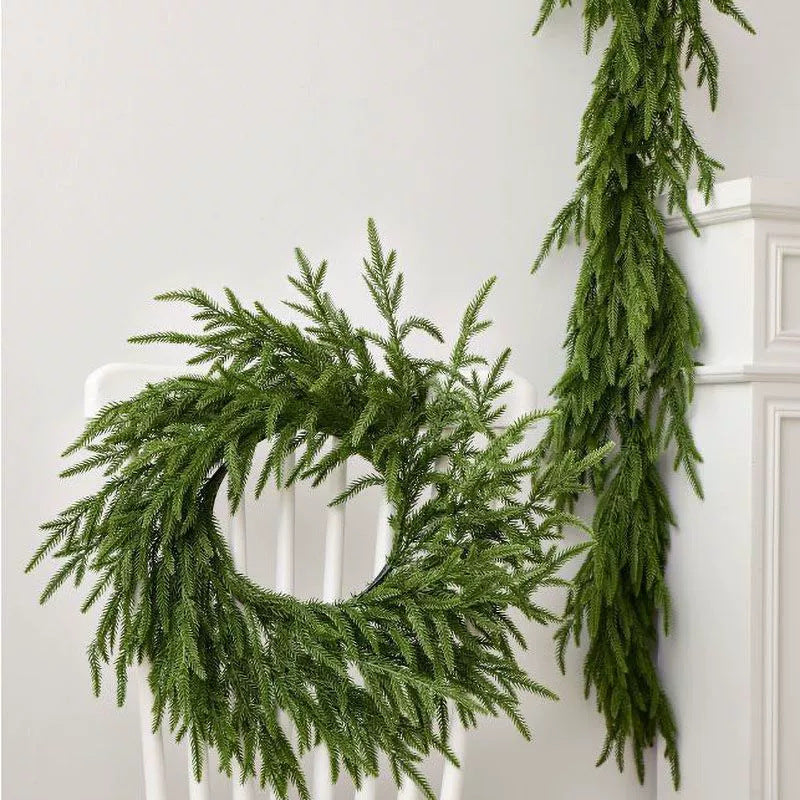 Green wreath and garland against a white wall
